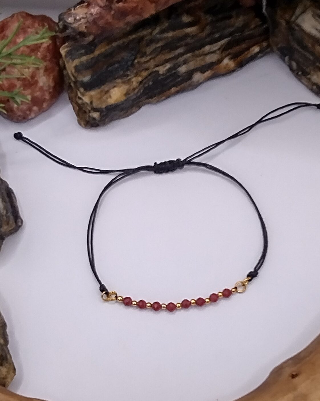 Bransoletka z czerwonego chalcedonu z złotymi przekładkami na czarnym regulowanym sznureczku